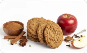 Apple cider - spice cookies with cinnamon sticks, star anise, cloves, and a red apple