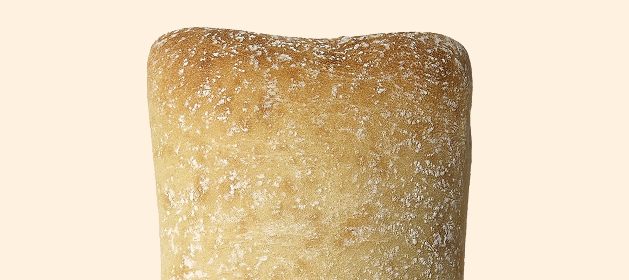 Crusty loaf of ciabatta bread Crusty loaf of ciabatta bread with a light dusting of flour