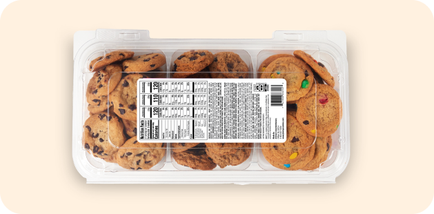 Assorted cookie packs in a clear container, including chocolate chip and M&M cookies