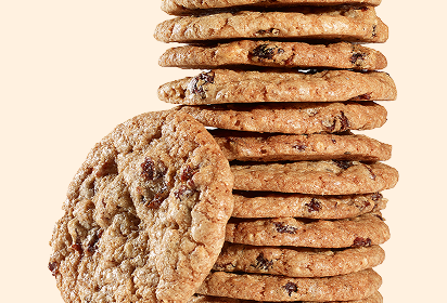 Thin oatmeal raisin cookies Stack of thin oatmeal raisin cookies, one leaning against the stack