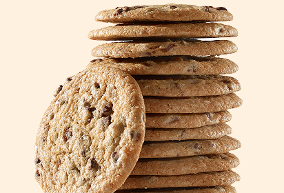 Thin chocolate chip cookies Stack of thin chocolate chip cookies with one leaning against it