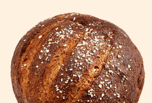 multigrain boule artisan bread Close-up of a multigrain boule artisan bread with oat flakes on top.