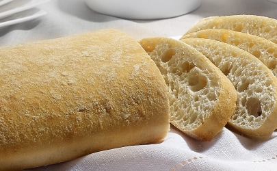 A freshly baked loaf of frozen bread A freshly baked loaf of frozen bread, sliced to reveal its airy