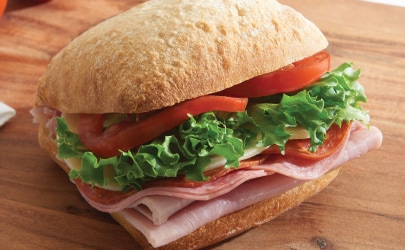 Fresh ham and salami sandwich Fresh ham and salami sandwich with lettuce and tomato on a classic artisan loaves